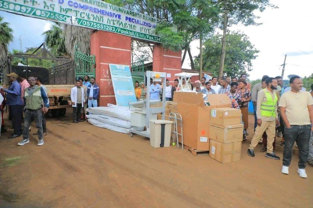 Medical equipment laid out in front of Dambi Dollo hospital gate with community gathered